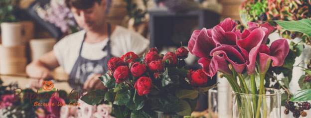 A florist making a boquet of flowers in her flower shop